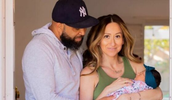 The Amastaes hold their new baby.