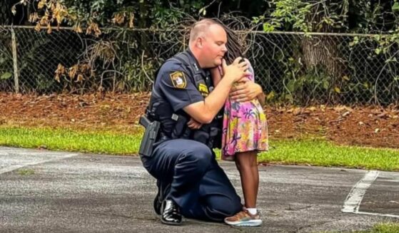 Interim Chief of Police David Snively consoles scared little girl after parent was arrested.