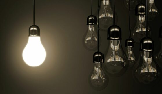 Light bulb shining in the dark.