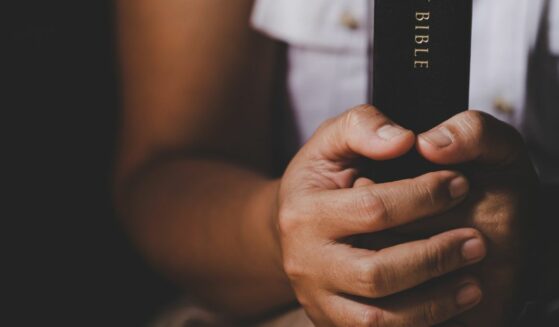 Holding Bible.