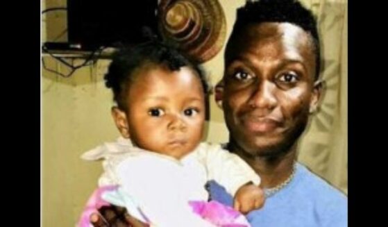 Jimmy Amisial and the child he is trying to adopt.