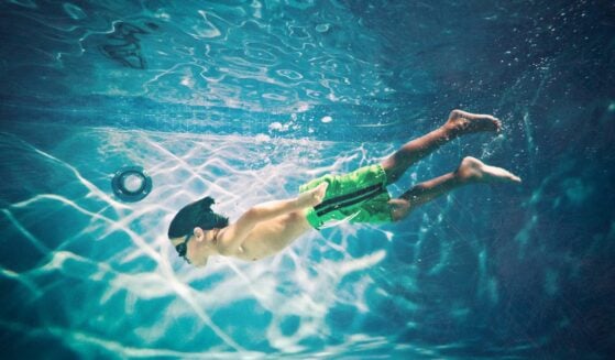 Kid swimming underwater.
