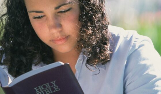 Teenager reading the Bible.