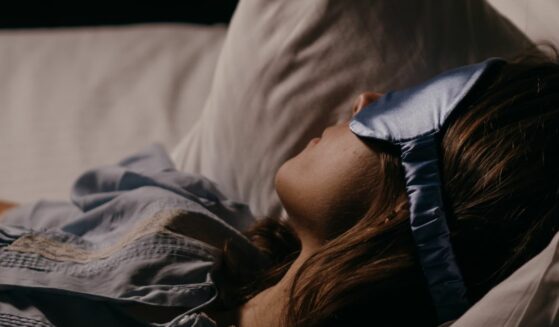 Asleep woman wearing an eye mask.