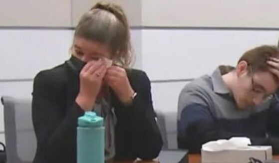 Assistant Public Defender Nawal Najet Bashiman, setting next to Cruz, wipes away her tears.