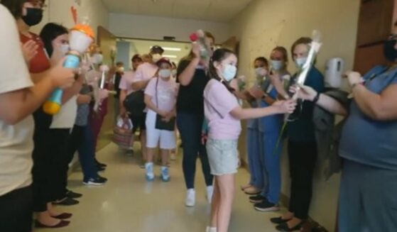 10 year-old Mayah Zamora passes out roses to the hospital staff the day she is discharged.