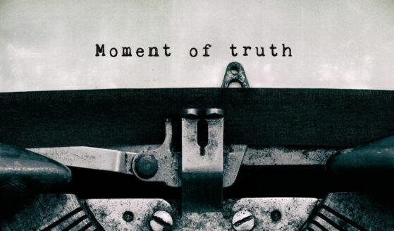 Moment of truth text typed on a vintage typewriter in black and white.