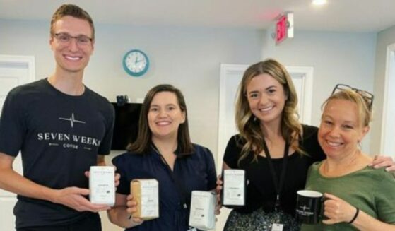 Seven Weeks Coffee poses for a picture with Hope in NOVA, one of their partnering centers.