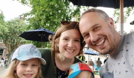 Matt Schlag with his wife and two children outdoors.