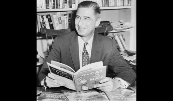 Theodor Geisel holding his best-selling book "The Cat in the Hat" in 1957.