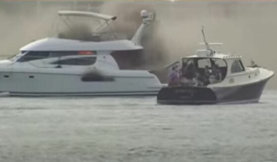Yacht on fire during rescue in Hudson River.