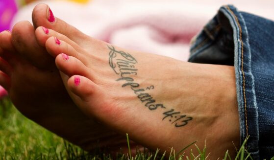 A motivational tattoo on a young woman's foot.