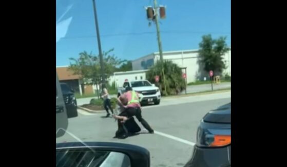 The young Chick-fil-A employee heard the woman's screams and ran to her rescue, tackling the alleged carjacker and wrestling him to the ground.