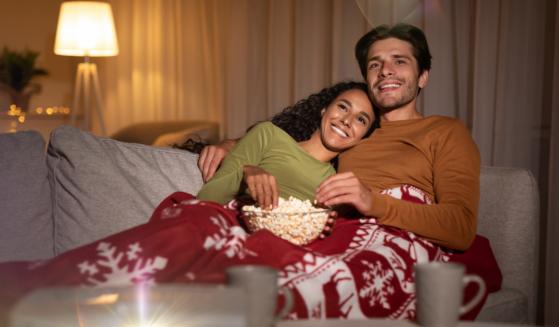 Couple watching Christmas movies at home: Hallmark