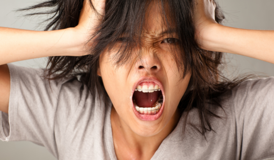 Deal with Anger: Photo of Woman Screaming (Goldmund from Getty Images Signature/ Canva)