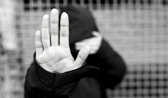 Photo of woman hiding face, close-up of refugee's hand. (nastyaphphotos/ Canva)