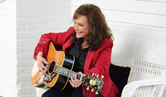 Loretta Lynn playing her guitar in June 2022