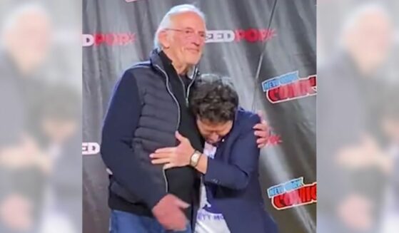 Michael J Fox hugs Christopher Lloyd at New York Comic Con.