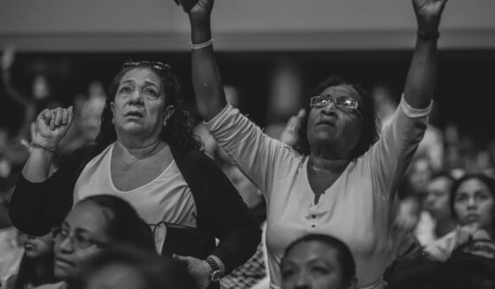 Grayscale Photo of People Worshiping