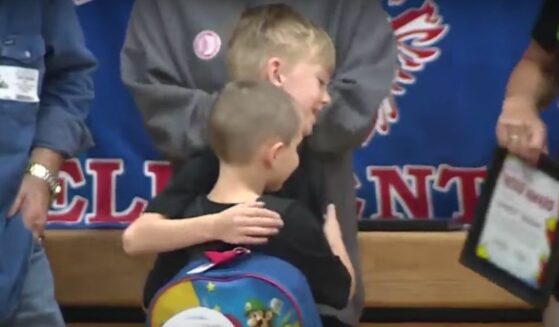 Garrett Brown gives his classmate a hug after saving the other boy's life