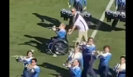 High school junior Casey Hubbard plays his trumpet in the marching band with the help of band director Adam Mewhorter.