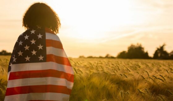 Girl wrapped in flag.