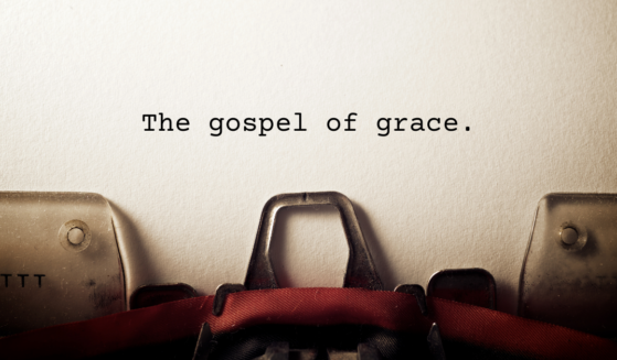 Typewriter with the words "The gospel of grace" appearing on the page.
