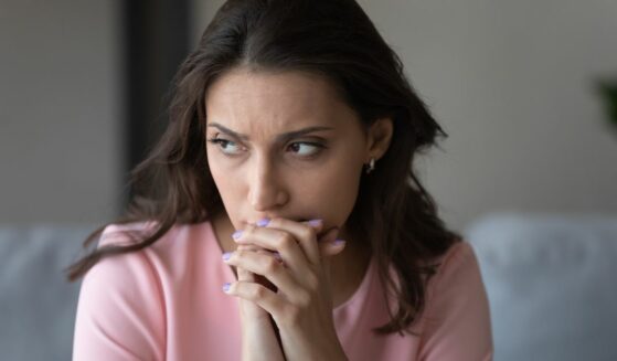 Worried woman looking away and contemplating.