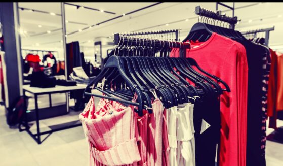 Women's clothes on clothes rack in department store.