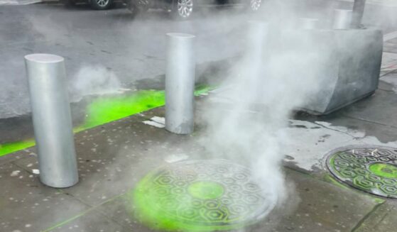 Green fluorescent water is bubbling up from the sewers of NYC street near World Trade Center.