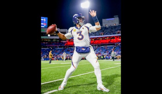 Russell Wilson in Bronco's jersey throwing a football