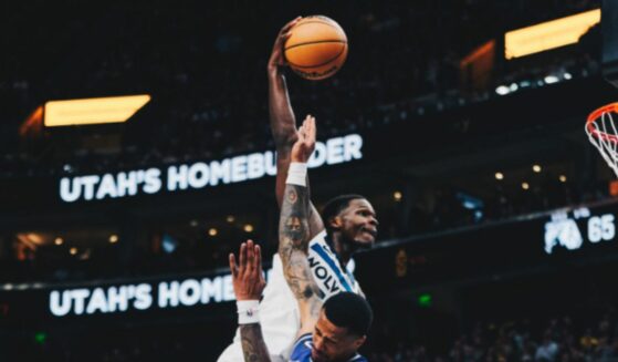 Anthony Edwards dunking on Utah Jazz player.