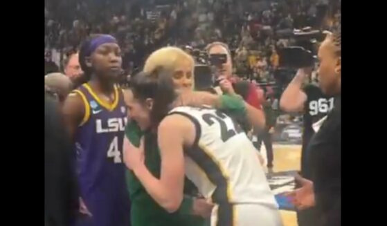 LSU Tigers women’s basketball coach Kim Mulkey, left, embraces Iowa basketball sensation Caitlin Clark, right.
